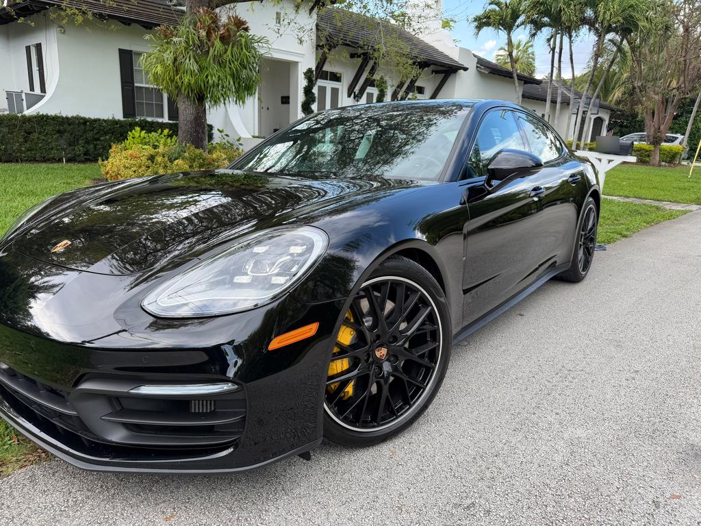 Black Porsche Panamera with yellow brake calipers